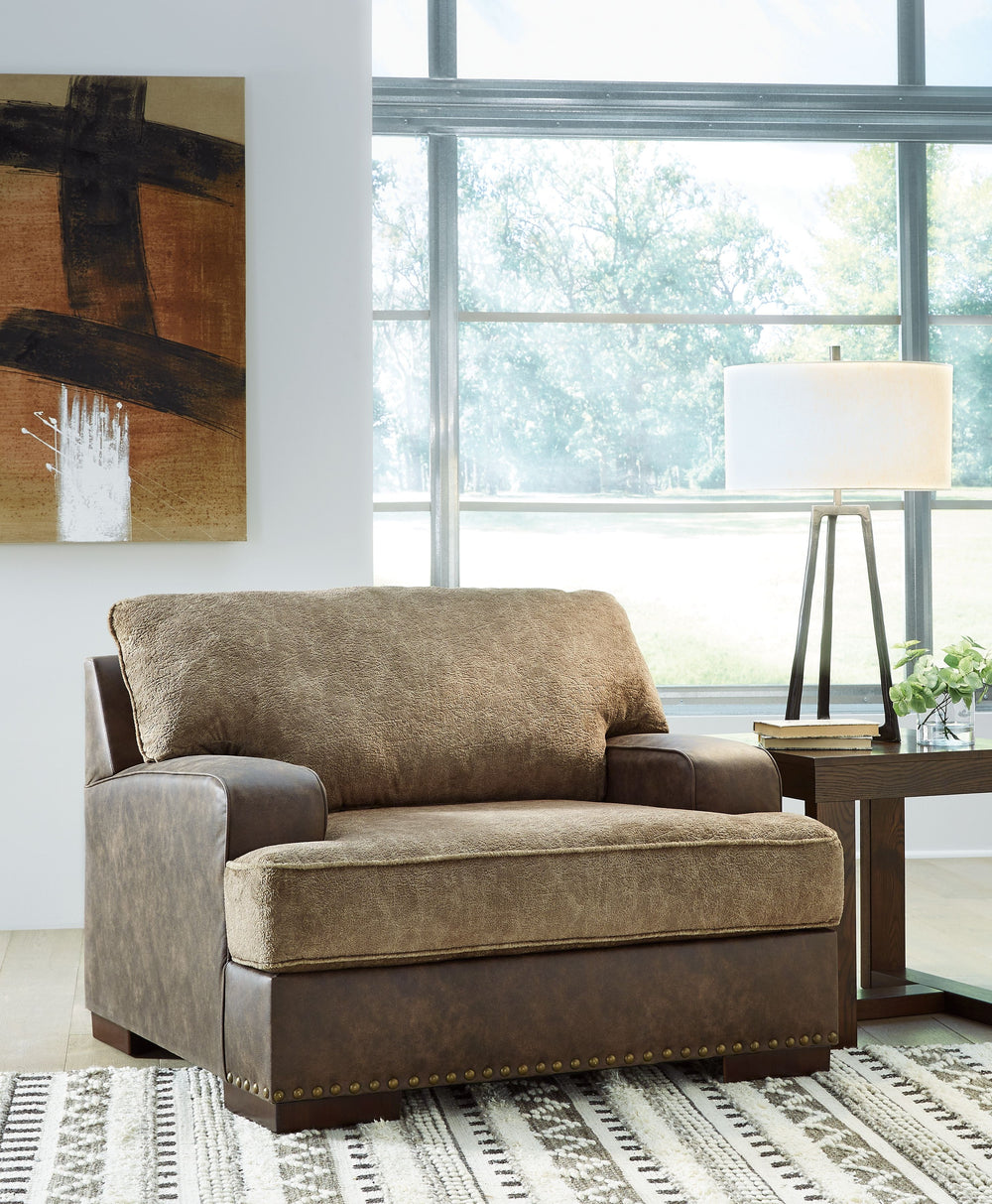 Punctuated by a subtle band of nailhead trim, this collection is perfect for those who love the look of leather. Two textural tones provide twice the style and comfortâ€”and incorporate an added layer of visual interest. Throw pillows add a fun decorative