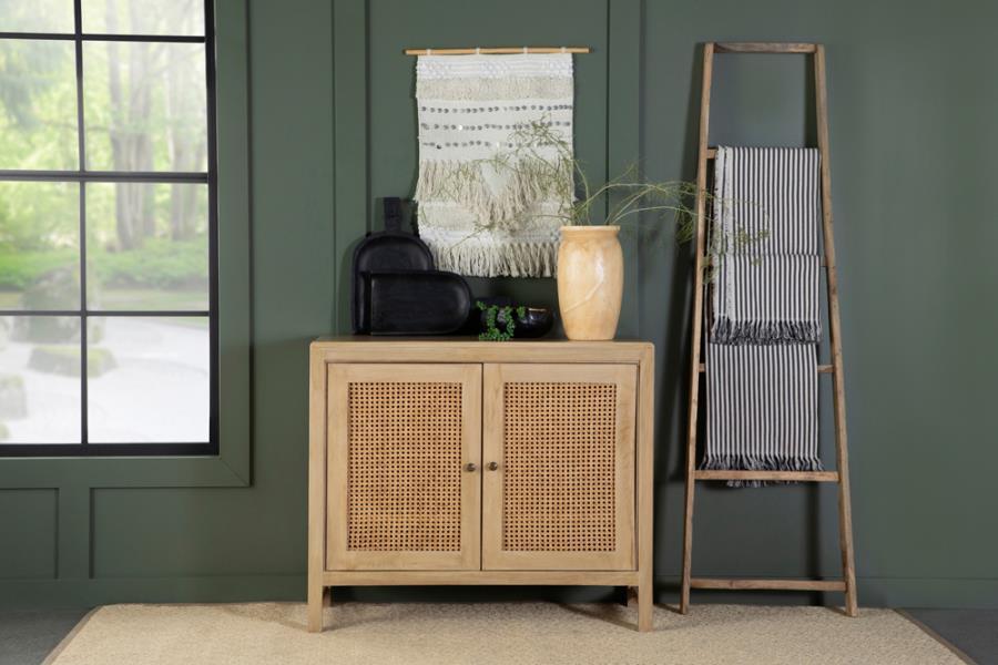 Bring warmth and texture to your space with this transitional accent cabinet, crafted from eco-friendly mango wood in a natural finish. The woven cane door panels add a touch of retro charm, while antique brass-finished hardware provides a subtle contrast