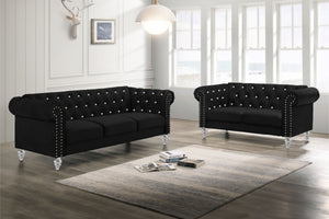 The New Classic Emma Chesterfield Velvet 2-Piece Sofa and Loveseat Set offers a soft and elegant seating solution for your living space. The 100% polyester velvet fabric provides cozy and indulgent seating, while the tufted backs and arms, adorned with gl