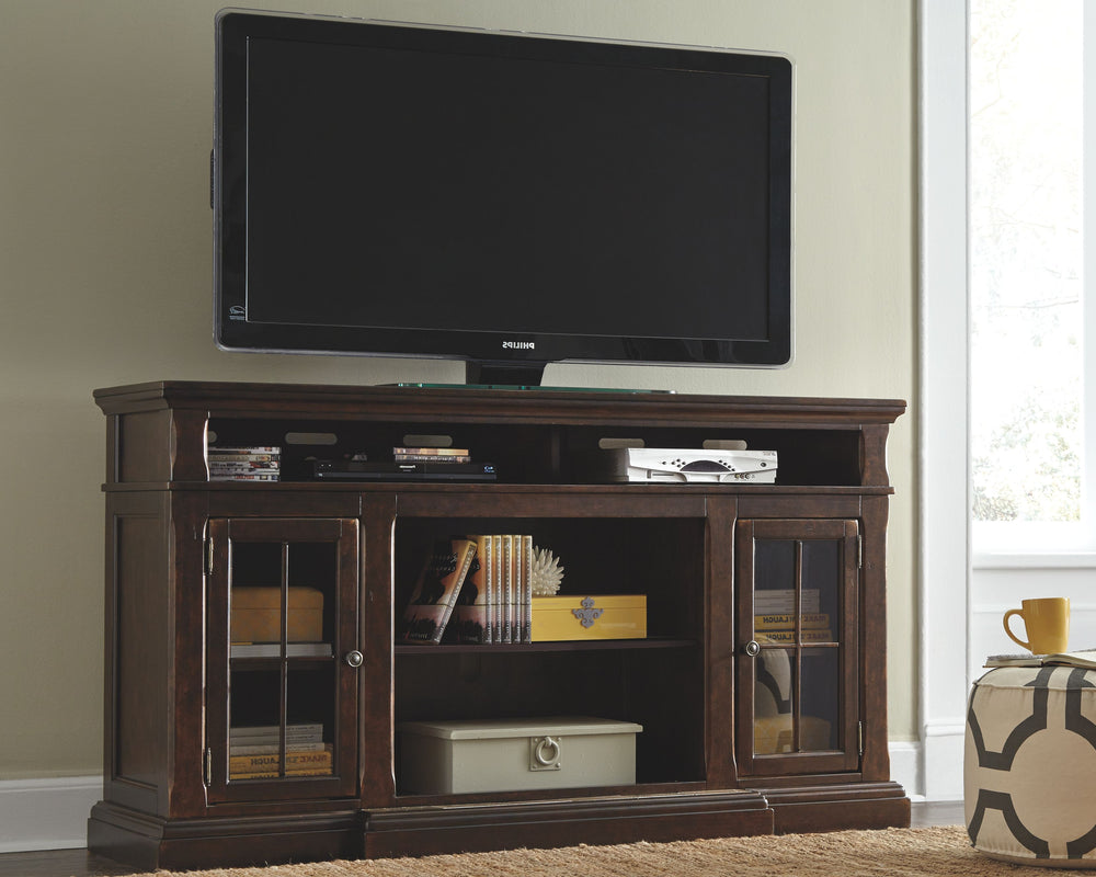The beauty of this TV stand will immediately engage you. The slight breakfront shape is a rare find and an ideal fit among traditional and eclectic tastes. Soft black undertones highlight the warm finish. Multiple cubbies and glass-door enclosed shelves o