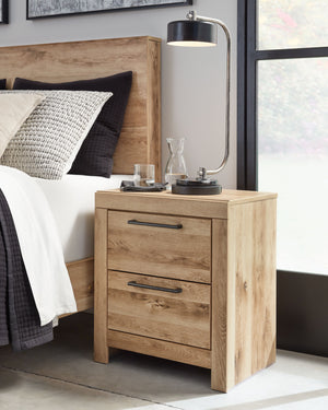  refined to perfection. This nightstand brings cozy outdoor vibes to your bedroom with its warm and inviting golden rustic finish. Antiqued gunmetal handles adorn the two drawers on its framed front for an industrial touch