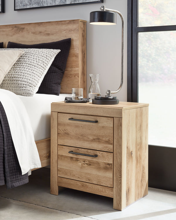  refined to perfection. This nightstand brings cozy outdoor vibes to your bedroom with its warm and inviting golden rustic finish. Antiqued gunmetal handles adorn the two drawers on its framed front for an industrial touch