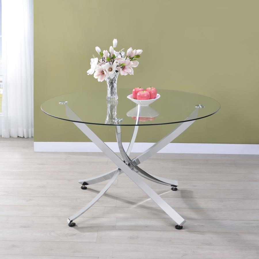 This round dining table offers a striking balance of clarity and form. A clear tempered glass top creates an airy presence, while the sculptural asterisk-style base adds dramatic visual interest. Crafted from heavy gauge metal, the base is electroplated i