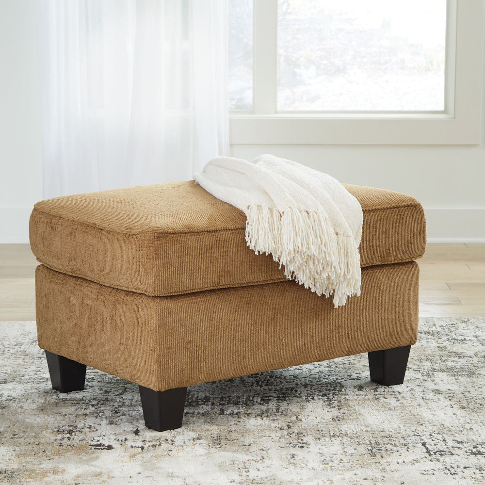 Thereâ€™s something about this ottoman thatâ€™s so easy to appreciate. Maybe itâ€™s the plush upholstery and comforting earthy tone, eager to support your quest for total relaxation. Perhaps it-'s the modern flair of its simple lines and tapered accent le