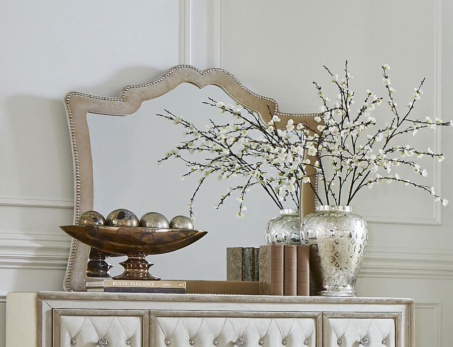 This stately mirror will bring a sense of French Provincial design into your sleeping space. Ideal for pairing with a matching dresser, this is an upholstered mirror with exceptional aesthetic details. A row of nailhead trim adds a textured element to the