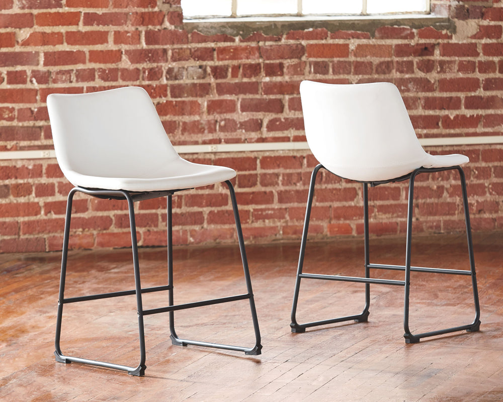 With its distinctive contoured bucket seat and tubular metal base, this bar stool serves up a fresh twist on mid-century inspired style. Contrasting white faux leather upholstery adds to the aesthetic. What a timeless look for eat-in kitchens and casually