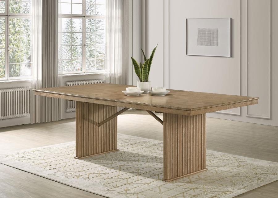 This dining table in a pearly almond finish combines modern elegance with natural textures. Crafted from oak veneer, Asian hardwood, and engineered wood, the table boasts a sturdy and stylish design. The base features striking vertical reeding side panels