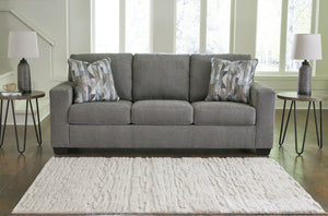  and the wide track arms are eager to support your quest for total relaxation. Distressed abstract toss pillows bring a fresh breath of contem