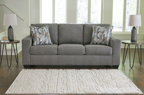  and the wide track arms are eager to support your quest for total relaxation. Distressed abstract toss pillows bring a fresh breath of contem