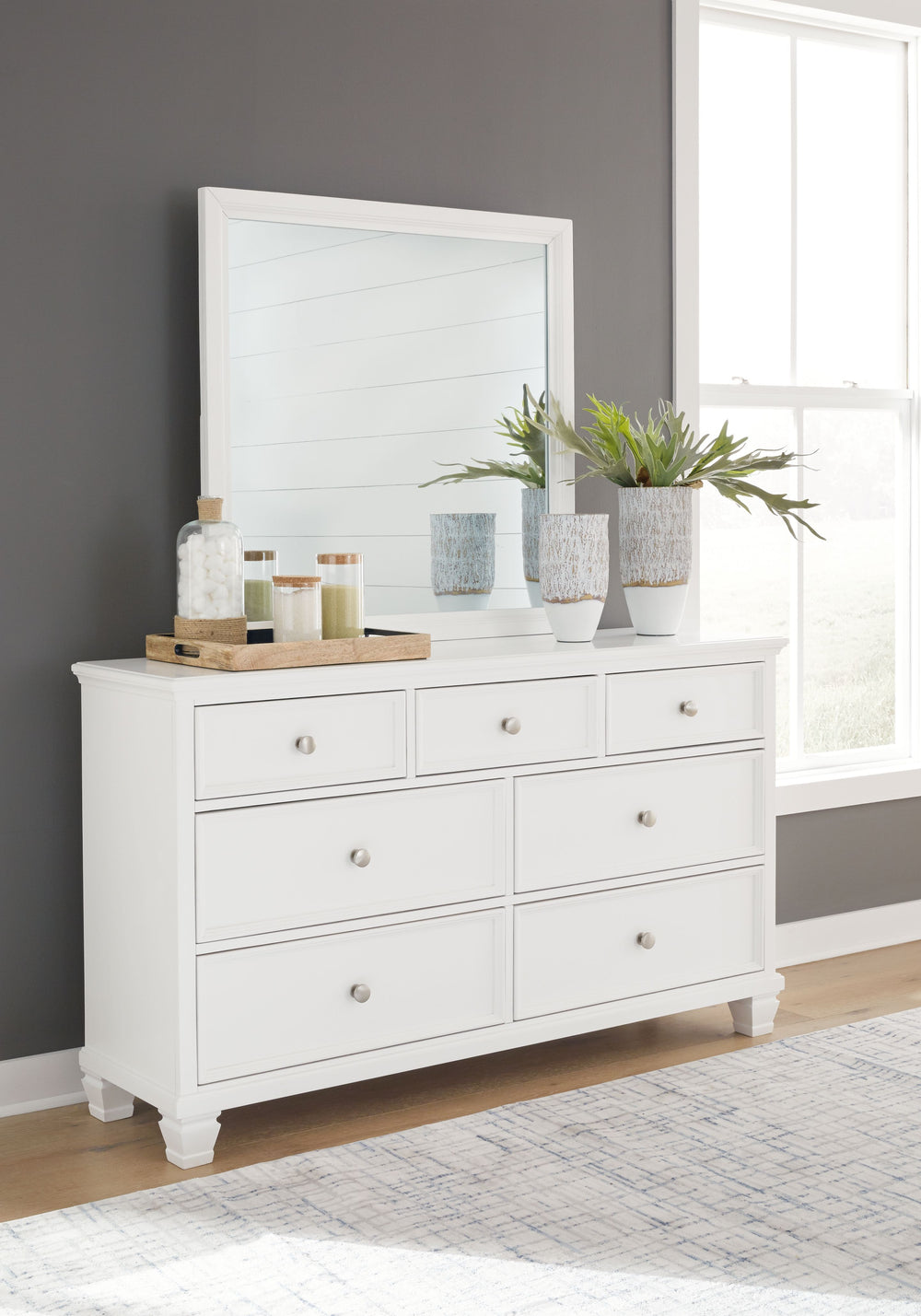 The casual design of this dresser and mirror introduces a time-honored look to your restful retreat. Spacious enough to hold all your essentials, the beautifully crafted piece is built to last. Distinctive framing gives its drawer fronts brilliant dimensi