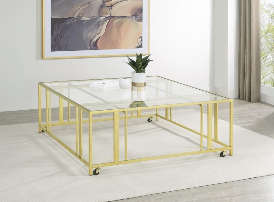 This square coffee table combines functionality with modern style, featuring a tempered glass top and a sturdy geometric base made from heavy-gauge metal. The open-frame design creates a sleek, contemporary look, while smooth-rolling casters add mobility 