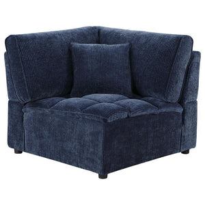 The corner chair seamlessly connects sectional components while maintaining style and comfort. Upholstered in soft blue corduroy with a pillow top grid-tufted design, it provides deep, supportive seating. The fully encased solid and engineered wood frame,