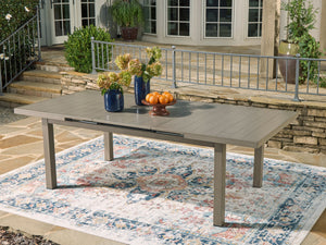  this dining table seamlessly brings your contemporary style outdoors. Sporting a wood-look finish
