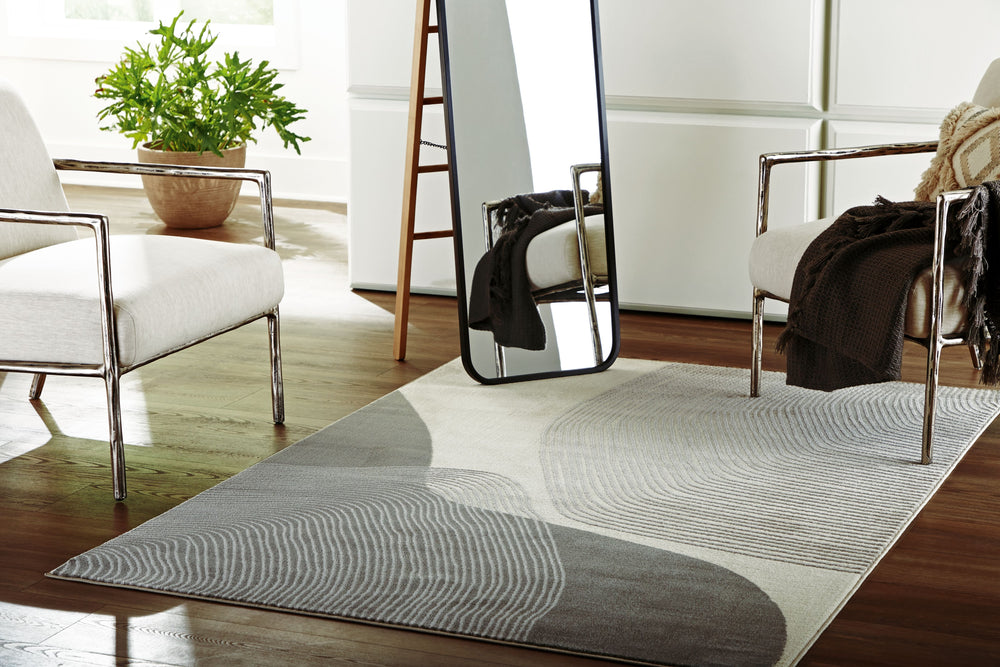 This area rug showcases a swirling abstract motif for a modern look. Providing a soft feeling underfoot, it gives flowing dimension to your hardwood or tile floors. It-'s a perfect fit for any home needing an extra touch of contemporary energy.<br/><br/><