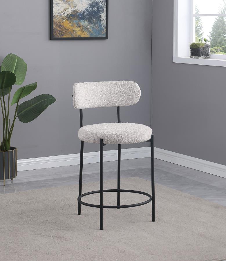 Your kitchen island or counter table gets an instant upgrade with this set of two modern barstools. The pair features contemporary boucle upholstery in a neutral hue over foam cushions for comfort. Metal framing features a black finish and provides excell