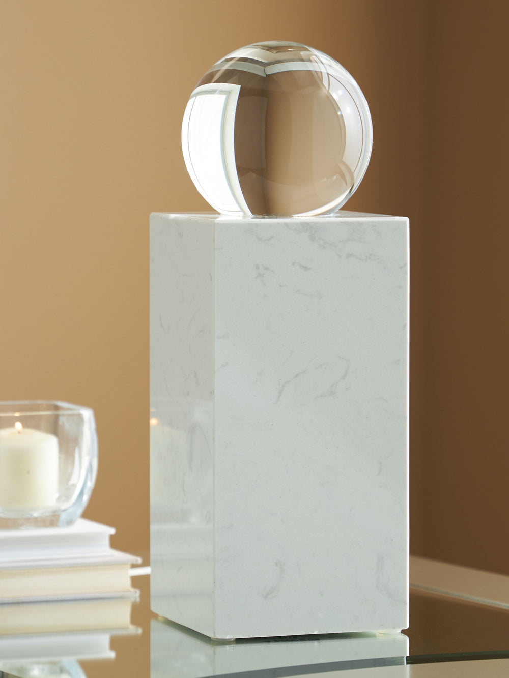 This exquisite sculpture effortlessly combines the purity of clear crystal with the timeless elegance of white marble. Contrasting textures and materials create a captivating visual experience, making it a striking focal point in contemporary settings. It