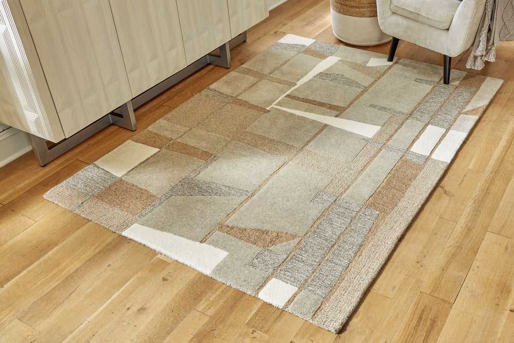 Abstract imagery and a medley of neutral tones give this rug loads of visual interest and a lot of versatility. The hand-tufted pile is rich with feel-good texture. Be it in casual gathering places or formal spaces, it has a look that feels right at home.
