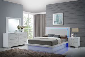 Elevate your bedroom with the Sapphire Modern 4-Piece Bedroom Set in high gloss white. This set includes a lighted panel bed, dresser, mirror, and nightstand, all crafted from premium manufactured wood for a flawlessly smooth surface. The sleek white lami