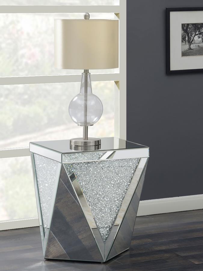 Dress up your decor with breathtaking, modern luxury. This mirrored end table combines a bold, diamond-shaped design with triangular panels of eye-catching, glittery material. The triangular mirrored surfaces create reflective beauty, while sparkling acry