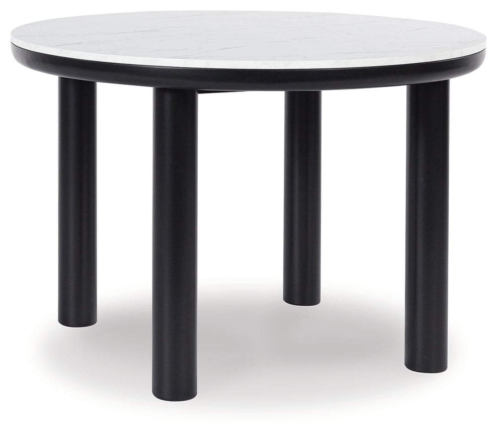 Clean lines meet cool curves with this dining table. Chunky round post legs and a black finish lend a modern vibe, while a replicated white marble top completes the casual lifestyle design. What a delicious choice for a dining room update.<br><br><b>Addit