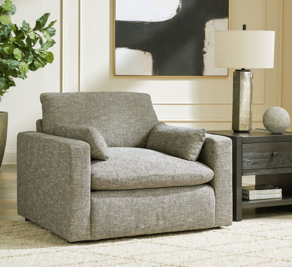  this oversized chair provides a positively plush seating experience. Its feather-fiber blend cushions invite you to float away in cloud-like comfort. Striking granite-hued upholstery and a streamline