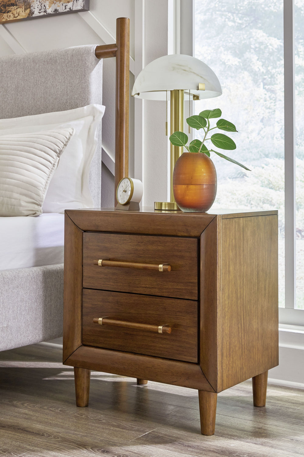 This nightstand is perfect for contemporary or mid-century interiors. Its wood-tone finish is versatile and timeless. Drawers with exquisite framing and elongated wooden pulls enhance the overall aesthetic, while USB charging keeps you connected. Whether 