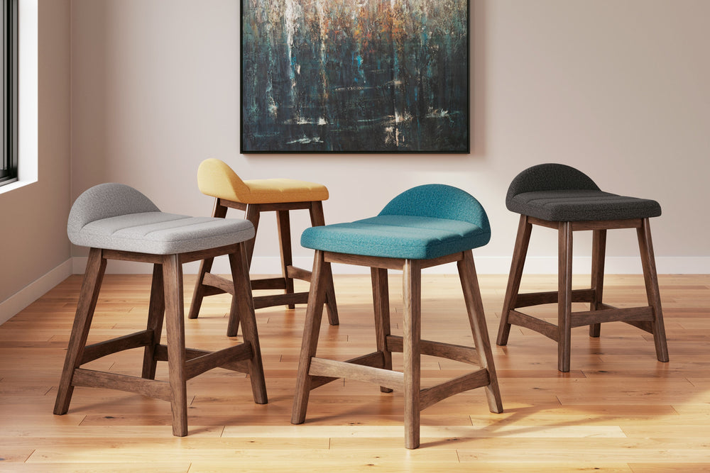 A refreshed take on retro aesthetics. This upholstered bar stool adds an air of playful simplicity to your dining space, capturing the architectural language of mid-century stylings. The seat invites the eye with a soft-edged silhouette and charcoal-hued 