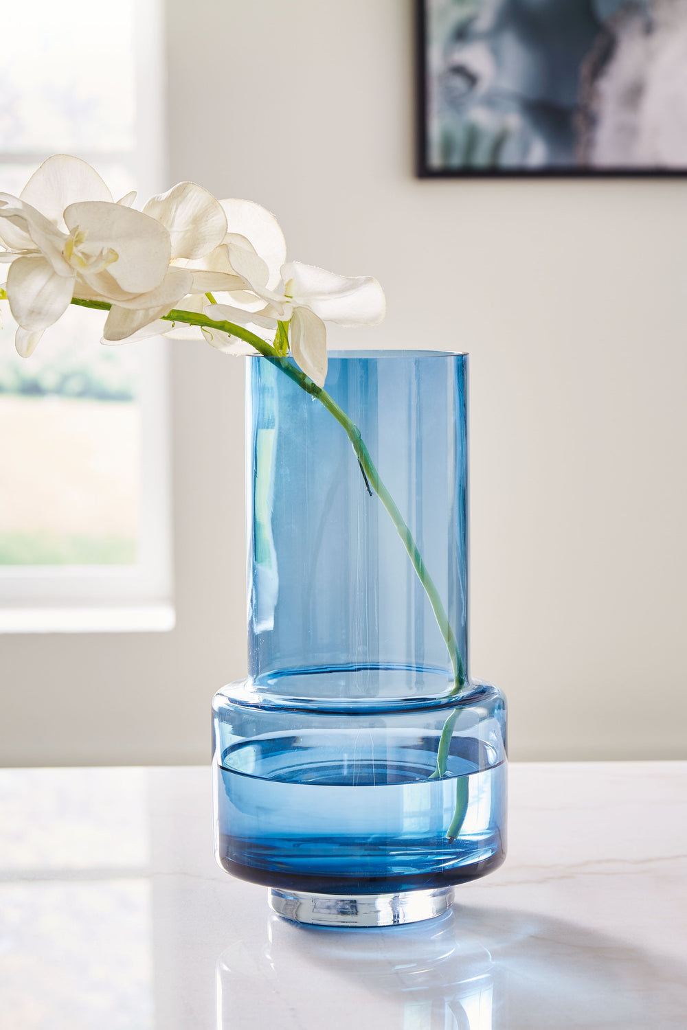 Bring a subtle pop of color to indoor and outdoor centerpieces with this vase. Its long, slim neck leaves plenty of room for your favorite florals or faux greenery. In a dark blue hue, this accent piece keeps your space looking contemporary cool.<br/><br/