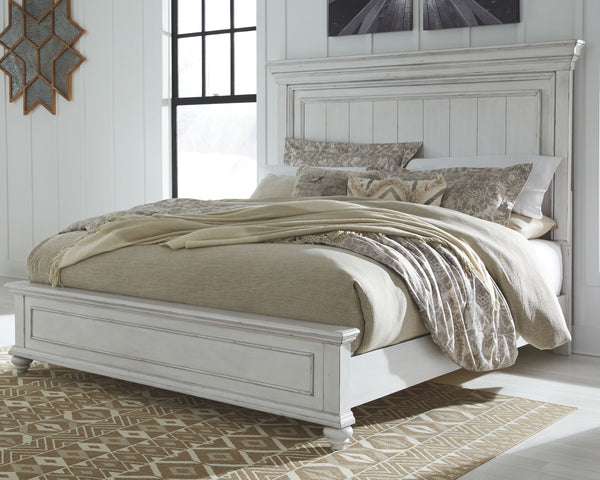 Give your retreat vintage charm with this king panel bed. In a beautifully distressed whitewash finish, you-'ll love the headboard-'s grand style featuring a picture framed panel. Generously scaled moulding from top to bottom, along with bun feet give thi