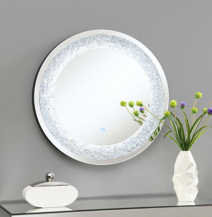 Add a glamorous glow to your space with this round LED wall mirror. Surrounded by a dazzling silver frame with embedded crystal-like accents, it blends modern style with everyday function. The integrated LED lighting provides soft illumination, making it 