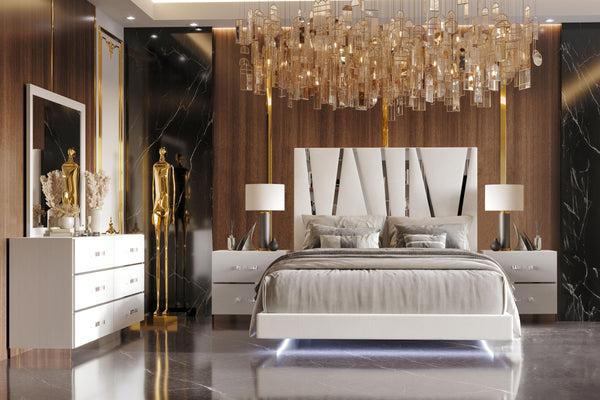 The Europa 5 Piece Bedroom Set in white offers a blend of modern sophistication and practical functionality. This set includes a panel bed along with a dresser, mirror, and two nightstands. The sleek design is highlighted by the majestic headboard, glossy