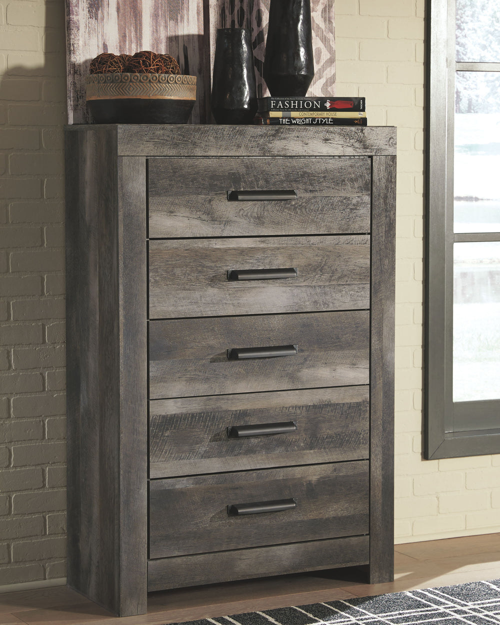 Rustic gray planked replicated oak grain with authentic touch. Large scaled dark colored hooded pull. Sticks across headboard give a thick planked look. Side roller glides for smooth operating drawers. Cases feature a framed front and pilasters. Large dra