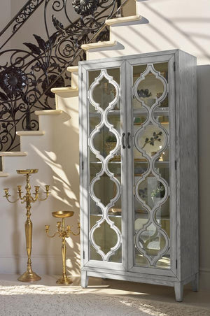  crafted with intricate lattice wood overlay and mirrored back panels for added depth and elegance. Framed glass doors open to reveal three shelves ideal for displaying collectibles or dinnerw