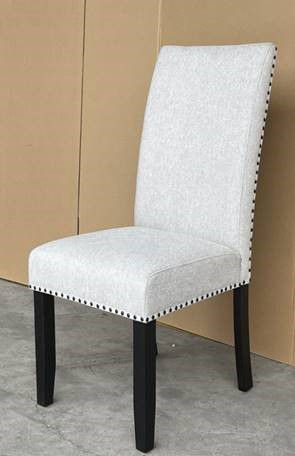 A fresh take on a traditional silhouette makes this group a great addition to your dining space. A genuine marble top is luxurious and timeless. The trestle base is updated in a contemporary charcoal finish. The upholstered dining chairs feature nail head