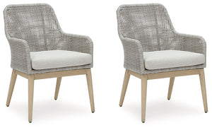 This dining arm chair invites your casual contemporary style outdoors. With its resin wicker in a chic neutral hue, it expertly marries refined design with durability. Breezy summer mornings and cold winter nights are made all the more comfortable with hi