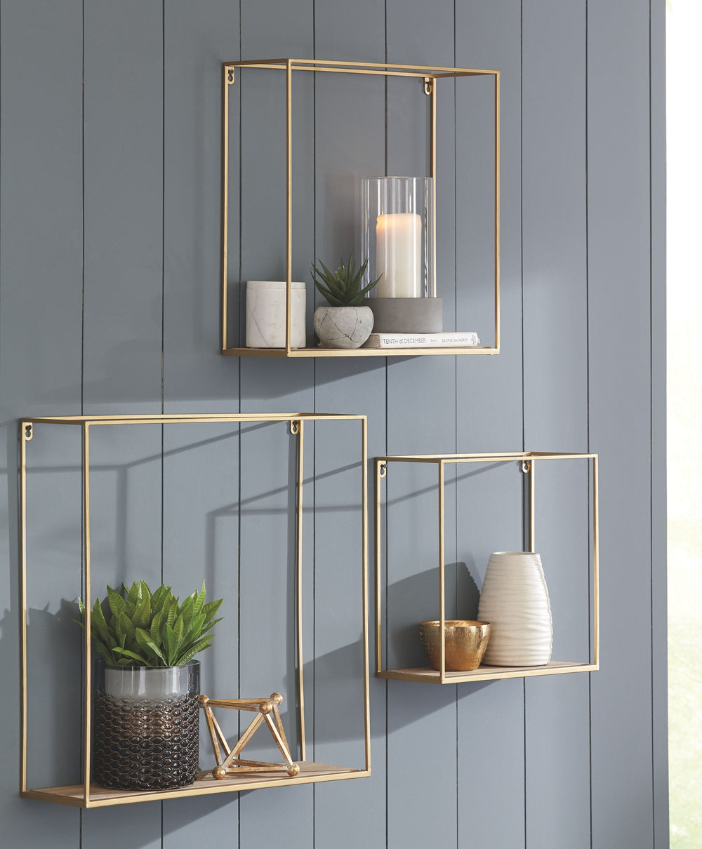 This 3-piece wall shelf set creates multi-dimensional appeal on your wall. Its linear design is elevated with an unexpected fashion-forward combination of goldtone metal and natural wood. Varying sizes give you the freedom to showcase what you want, where