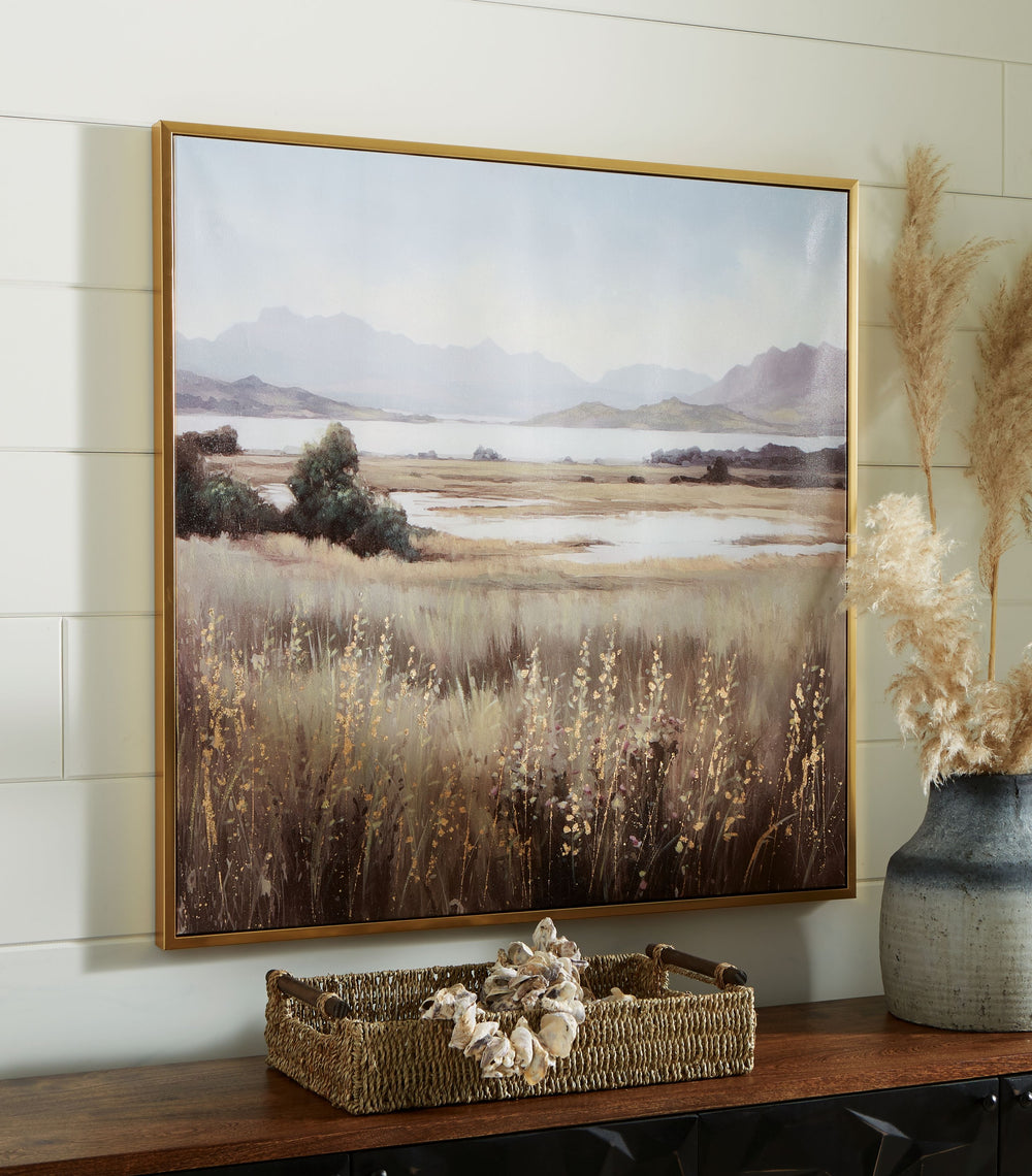 This wall art puts a peaceful spin on hanging decor. Its quiet landscape invites you to a lakeside field, with rolling mountains in the background that bring depth to the design. Hand-painted and gold leaf embellishments make each piece unique.<br/><br/><