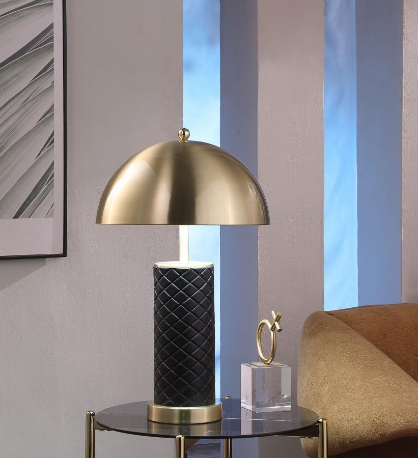 Bold and sculptural, this matching set of dome table lamps blends quilted texture with a sleek metallic finish. The rounded dome shades cast warm downward light, perfectly balanced atop cylindrical black bases wrapped in a quilted pattern for added depth.