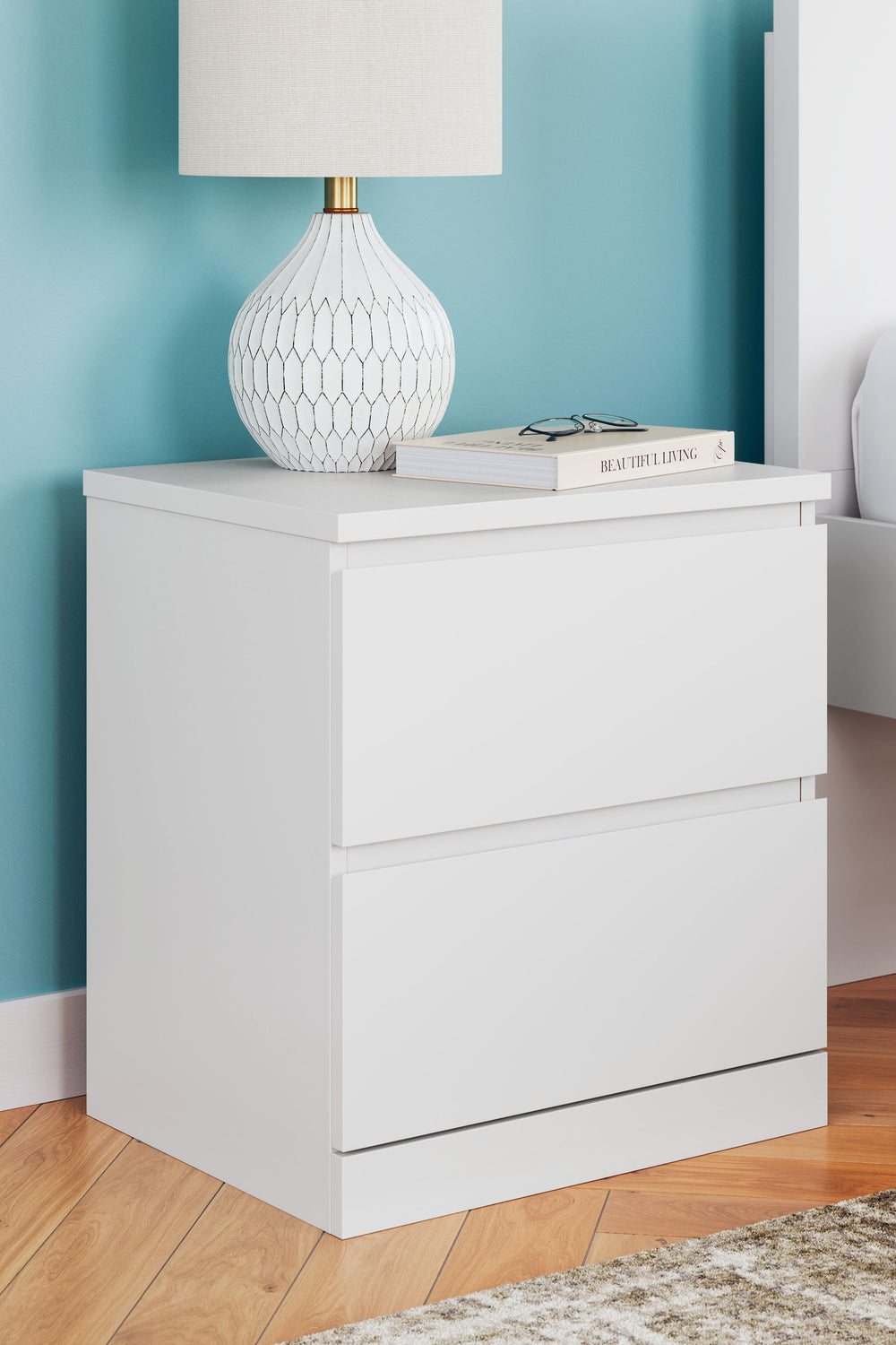 Create the modern bedroom of your dreams. This nightstand offers a minimal design with maximum style, combining ultra-clean lines and an easy-elegant solid white finish with a hardware-less aesthetic. Drawers with ball-bearing glides keep bedside essentia