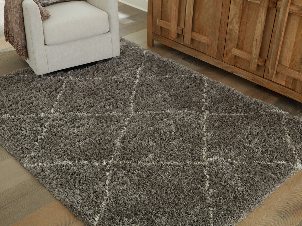 When is a rug more than a rug? When it invites you to kick off your shoes and stay a while. This shag rug welcomes visitors with warmth and a tantalizingly thick, plush pile. Its neutral color palette exudes a casually cool vibe that works wonders whereve