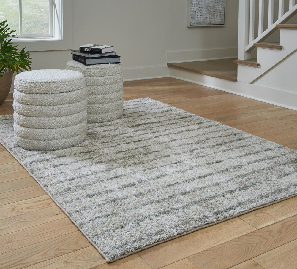 If thereâ€™s any rug that beckons you to slip off your shoes and sink your toes into true comfort, this area rug is it. Just imagine how good the plush woven shag will feel underfoot. And its dreamy, creamy color with sage stripes? The ultimate choice for
