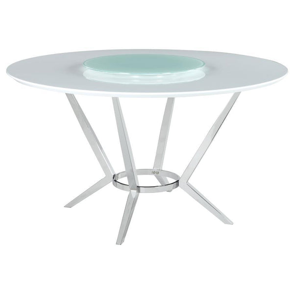 Elegant and ultra-modern, this round dining table pairs a high gloss white top with a tempered glass lazy Susan for added function. Its metal base features boomerang-style legs finished in electroplated chrome, delivering sculptural appeal and stability. 