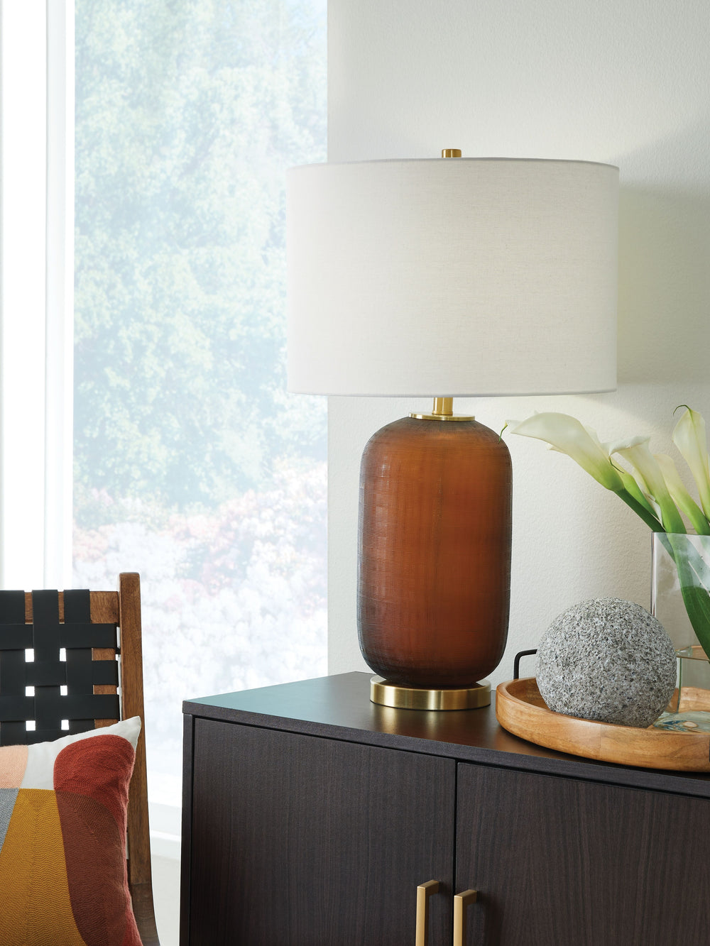 Clearly a contemporary choice. This table lamp wows with understated elegance, thanks to its rich amber-hued glass base enhanced with goldtone accents. Whether your decor is modern or eclectic, you-'ll love how it lightens the mood and brightens a space.<