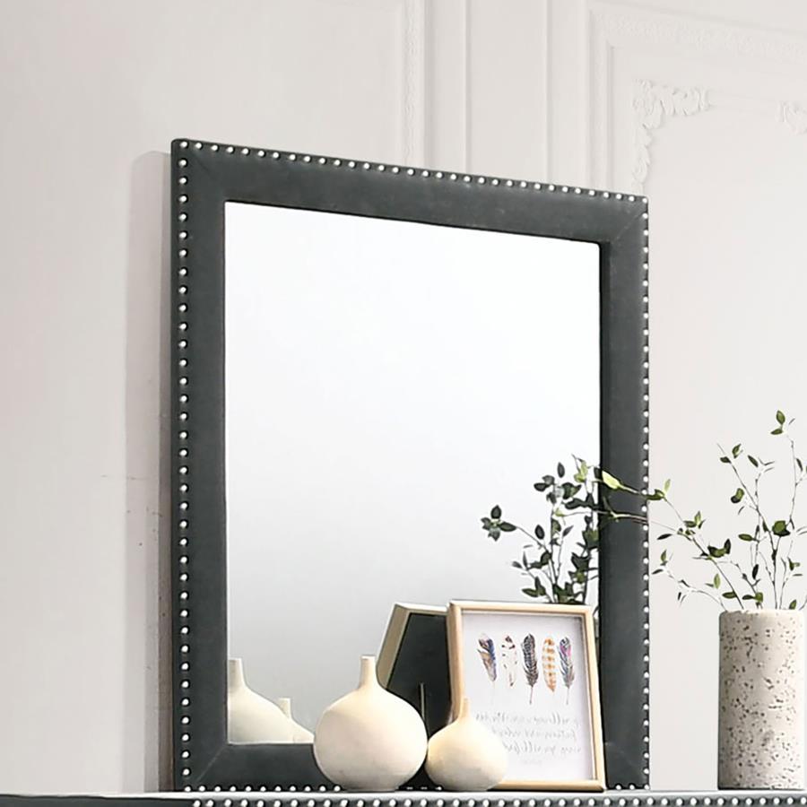This gorgeous mirror is a masterpiece made for royalty, ready to perk up your sleeping space. Its admirable frame is upholstered entirely in gorgeous velvet fabric. Nail head trim surrounds the frame for a sleek and exquisite upgrade. Place this mirror on