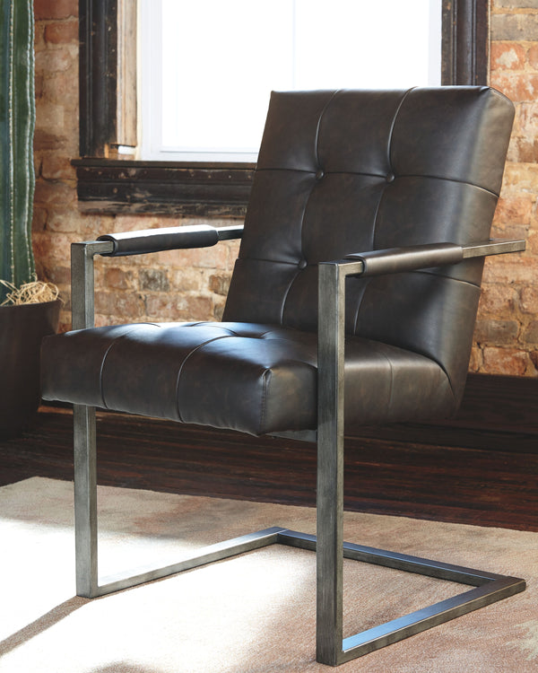  this chair steals the show. Its metal C-frame in a blackened gunmetal finish is sleek