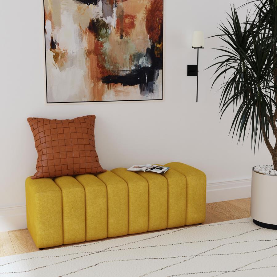 Introduce glam texture and dimension with a decorative upholstered bench. This modern creation features an undulating silhouette without arms or a back, offering sleek style and seating. Perfect for a sophisticated foyer or living room, it adds a pop of c