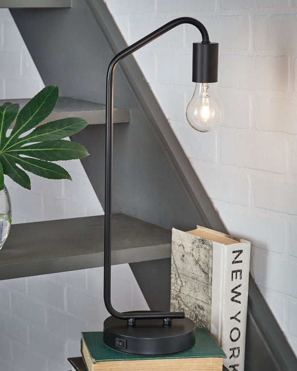  this desk lamp suspends its exposed bulb in one sleek swoop. Constructed of metal