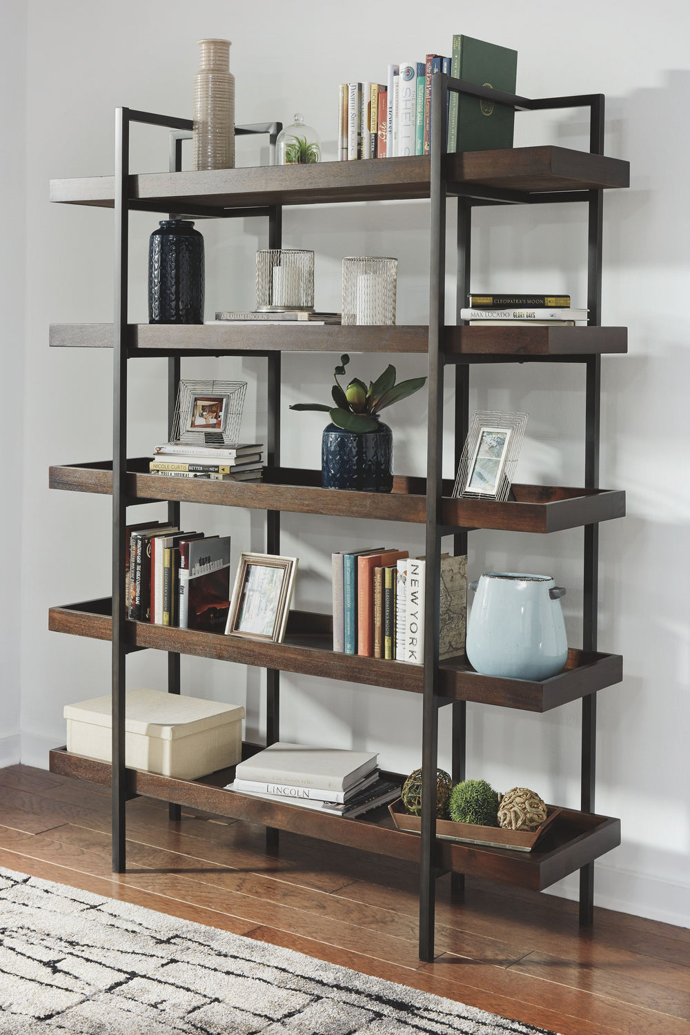 If youâ€™re a fan of urban industrial design, itâ€™s easy to see why this bookcase is a bestseller. The metal frame is sleek, sculptural and ultra modern. Beautified with an oiled walnut-tone finish, five gallery shelves stack up to great form and functio