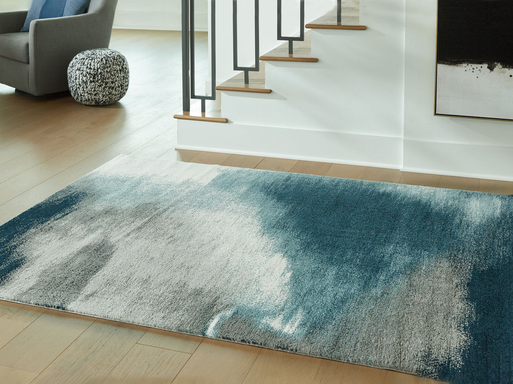 Bring bold, contemporary appeal to your decor with this rug. Crafted with curated style in mind, its blue, gray and ivory hues come together in luxe harmony. Layer the rug on the floor of your living room or bedroom for an utterly indulgent effect.<br/><b
