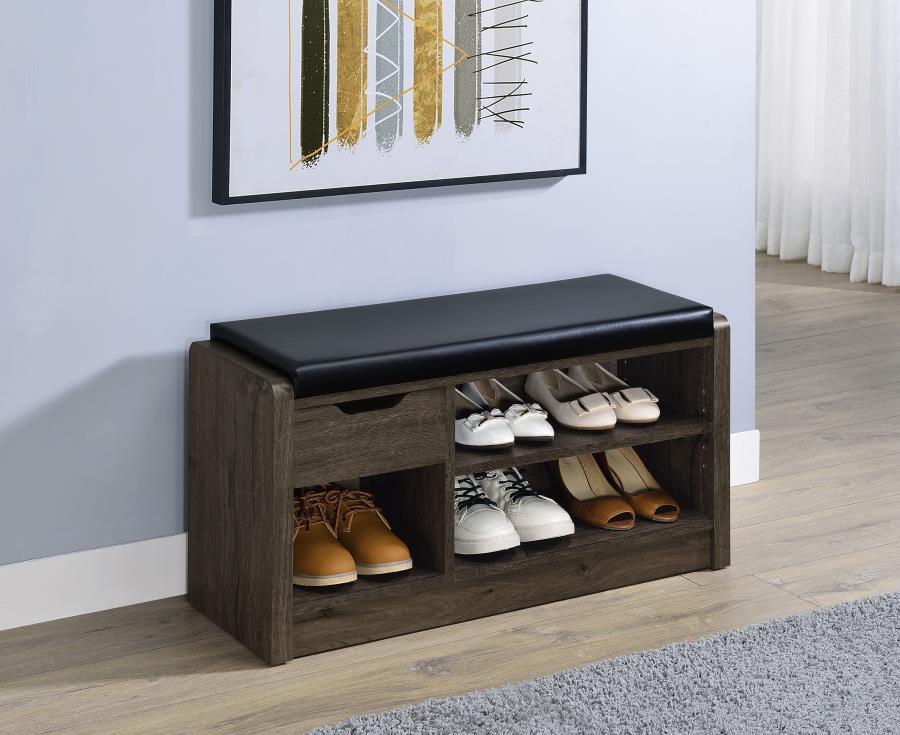 Make your entryway or garage both functional and stylish with this versatile storage bench, designed to keep your space organized. Featuring a foam cushion upholstered in sleek black faux leather, this bench offers a comfortable seat while you put on or t